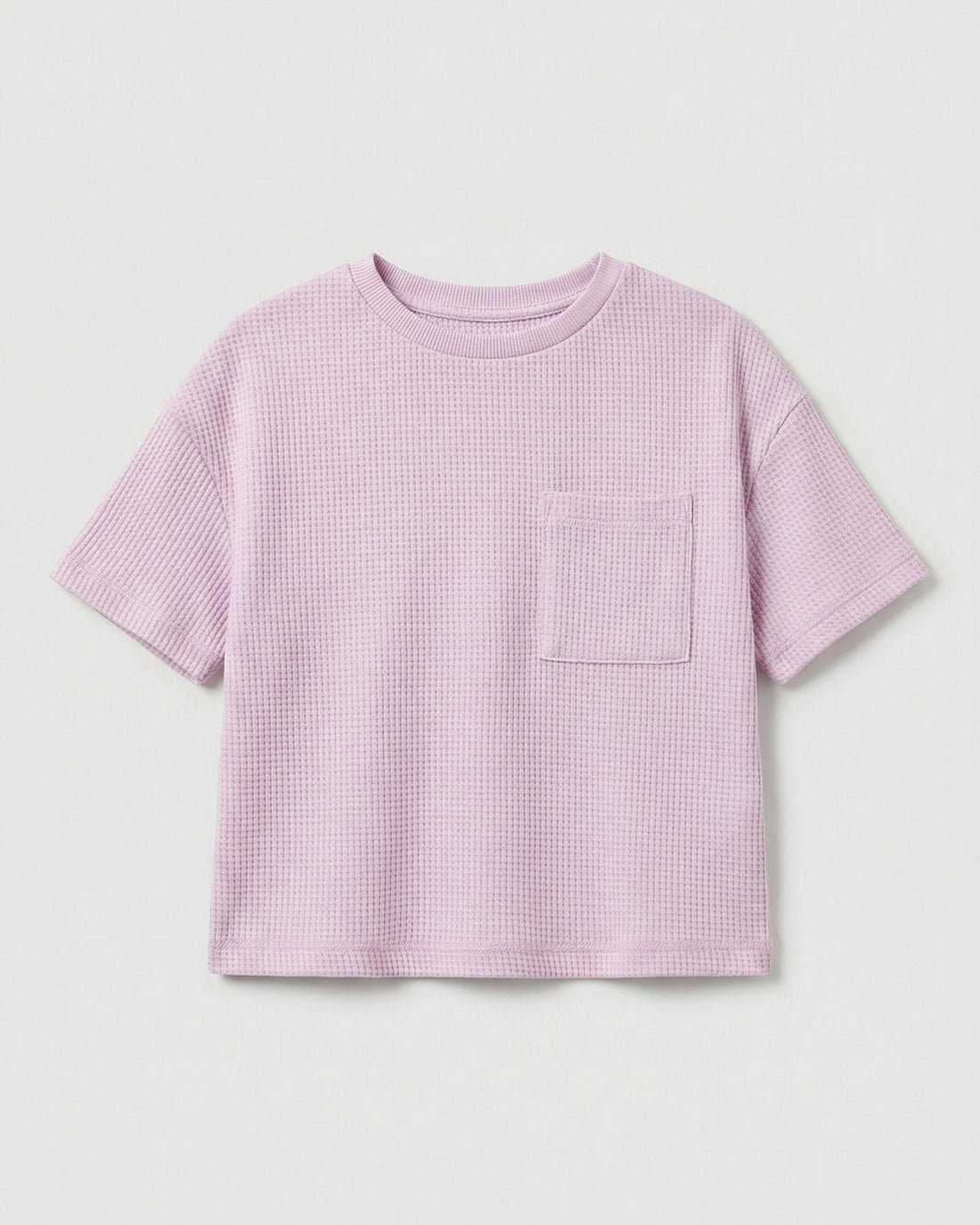 Toddler girls' waffle-knit cotton t-shirt in pink lilac with a ribbed crew neck, short sleeves, and a chest patch pocket, laid flat on a light grey background.