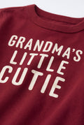 PTex Fashion baby tshirt close-up showing ribbed crew neck and cream Grandma’s Little Cutie lettering