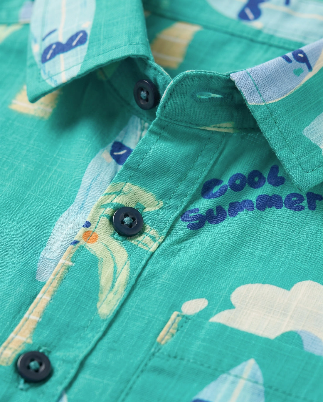 Flat lay of a PTex Fashion green remi cotton shirt for boys with palm tree and surfboard print
