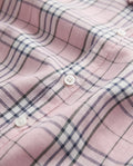 Close-up of pink check fabric and white buttons on a PTex Fashion boys' cotton shirt