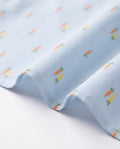 Fabric close-up of a PTex Fashion cotton shirt with orange and yellow carrot print