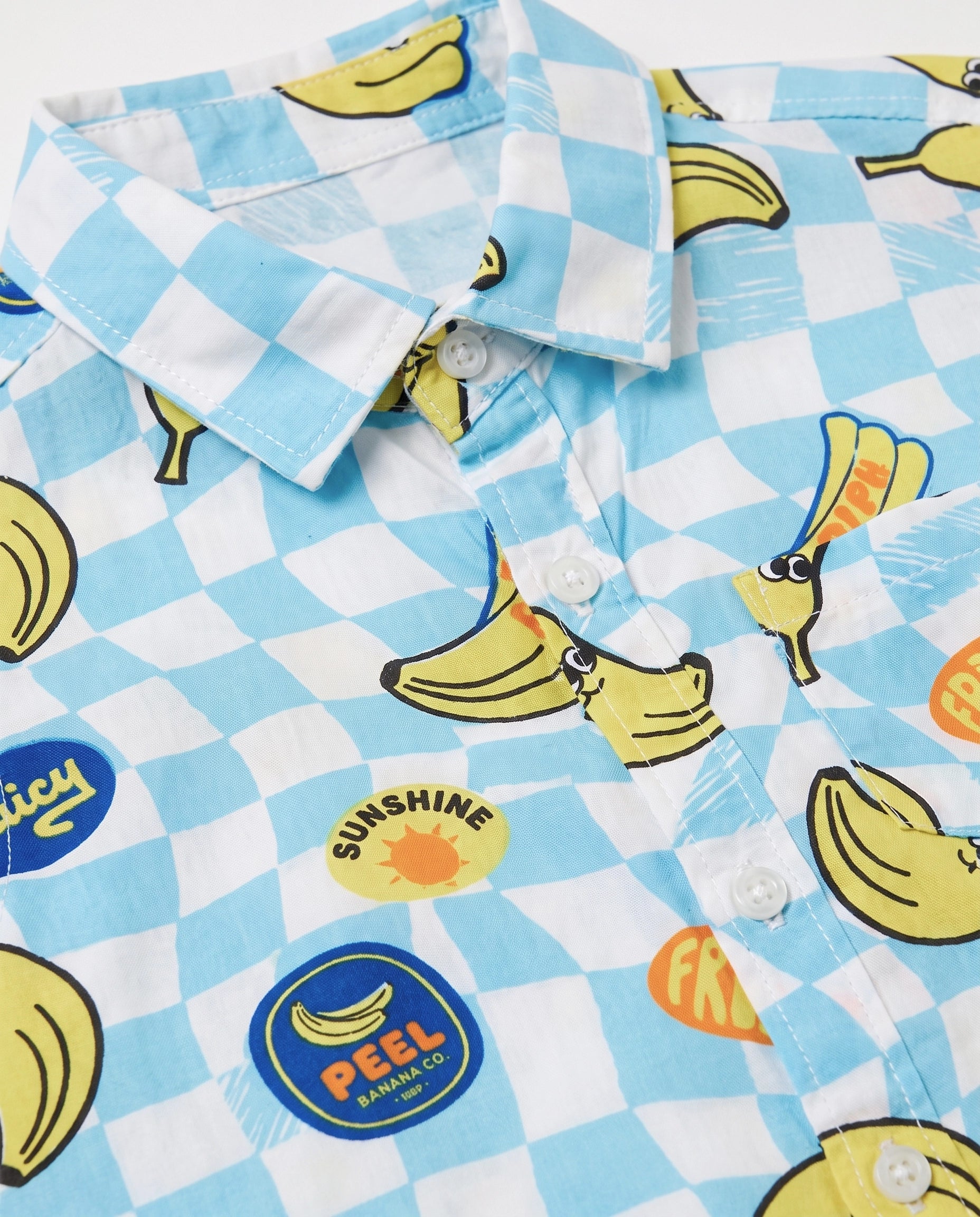 Collar and button detail on a PTex Fashion banana print sky blue checkerboard shirt for boys